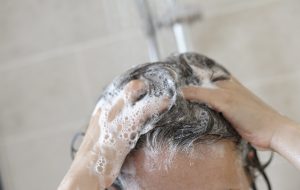 lady washing Greasy Hair in shower