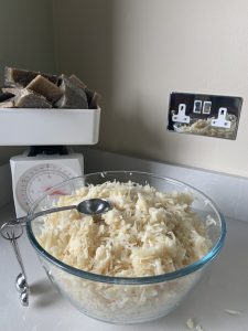 Measuring soap scraps on a weighing scale and bowl of soap scraps